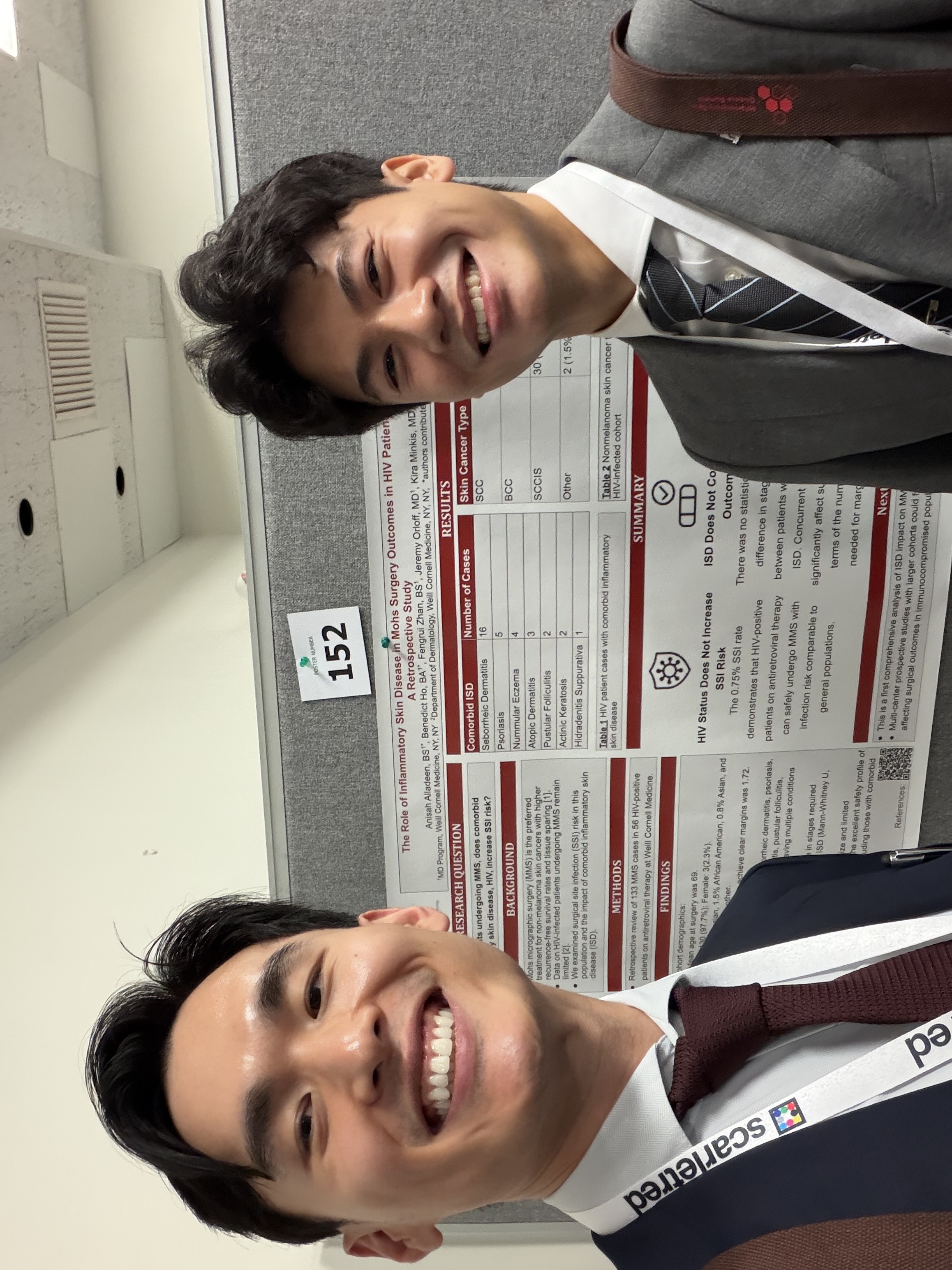 Researchers presenting poster about HIV patients and inflammatory skin disease